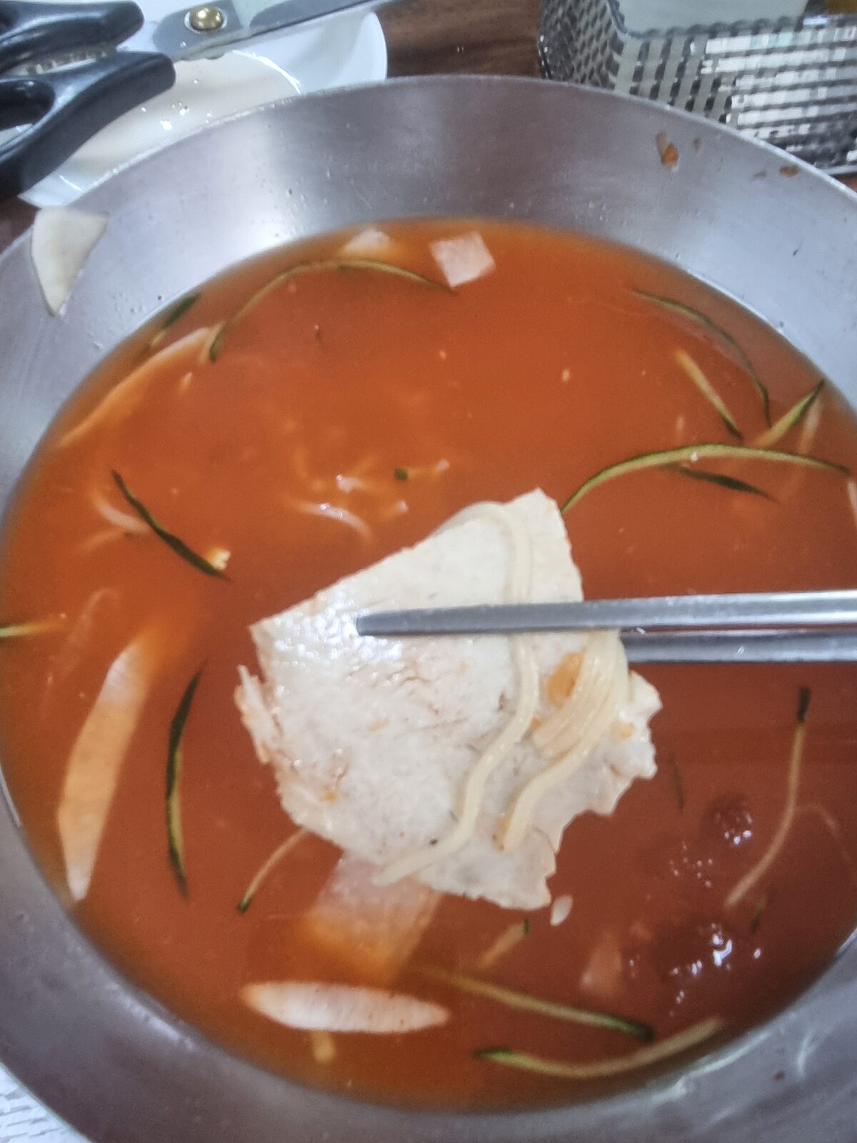 Boiled pork slices on top of Busan milmyeon