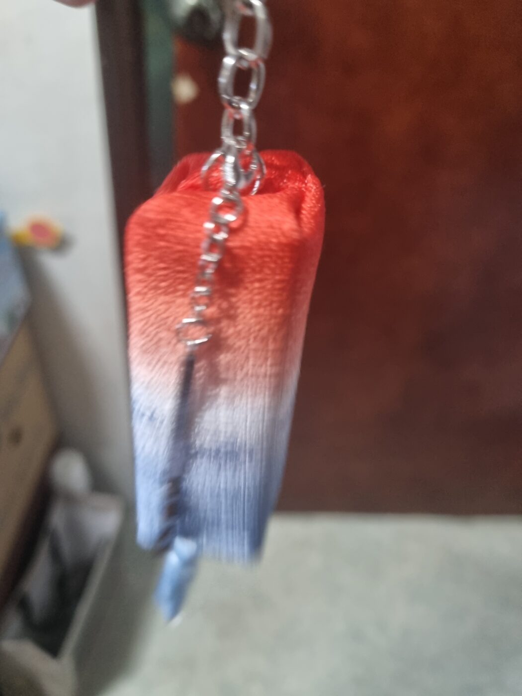 Cheongsachorong lantern keyring lit up glowing through silk fabric