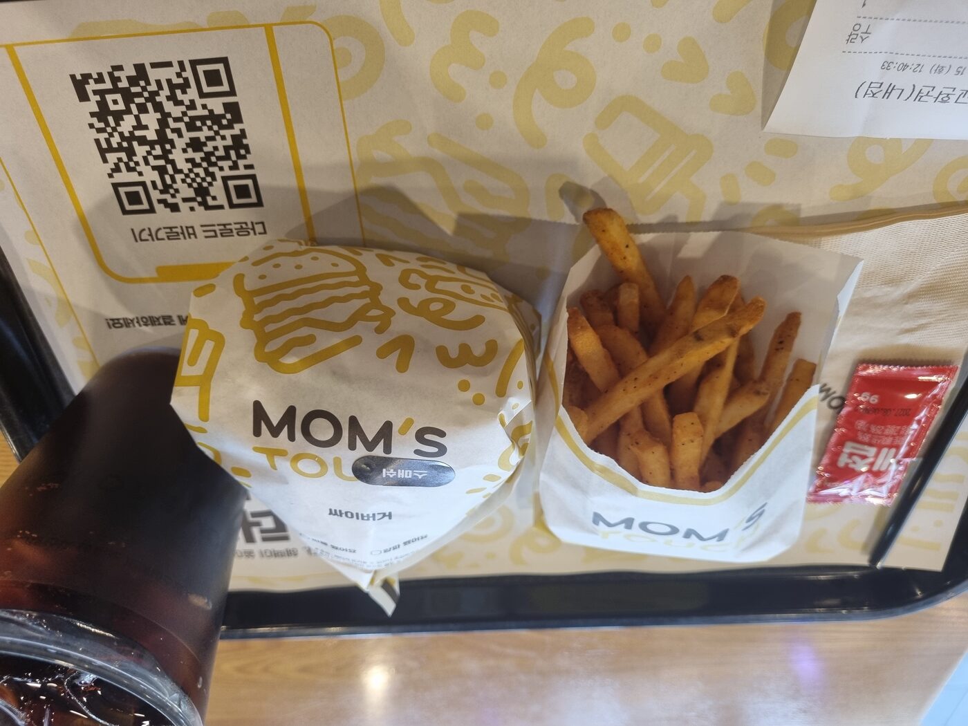 Mom's Touch Smash Burger set tray with cajun fries and cola
