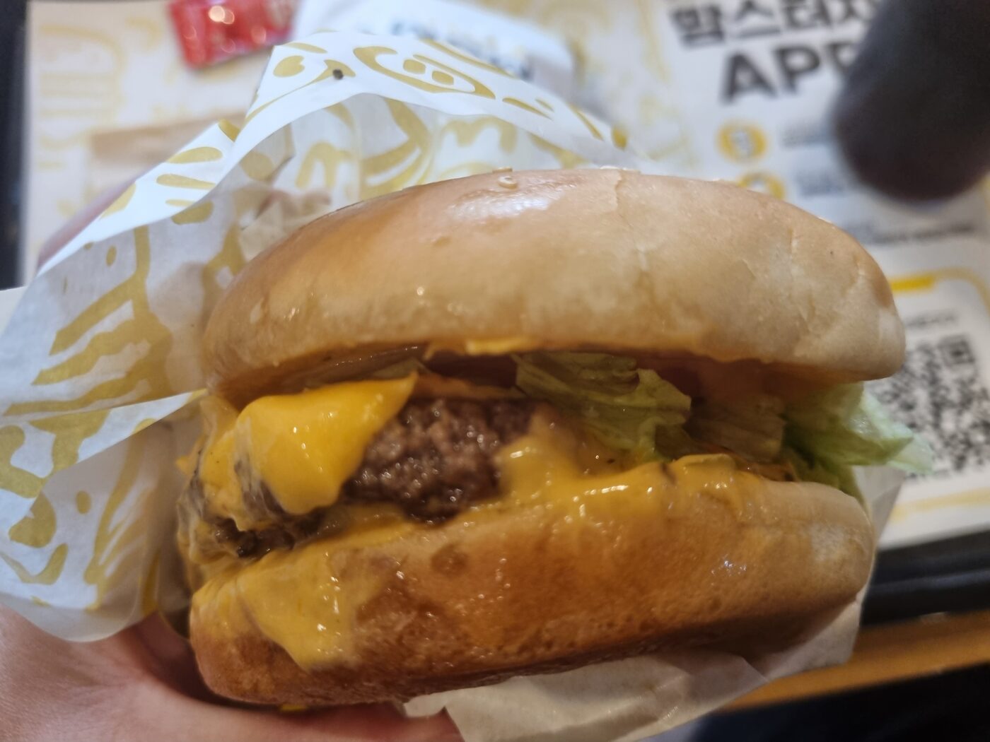 Mom's Touch Smash Burger wagyu patty melted cheese lettuce close up