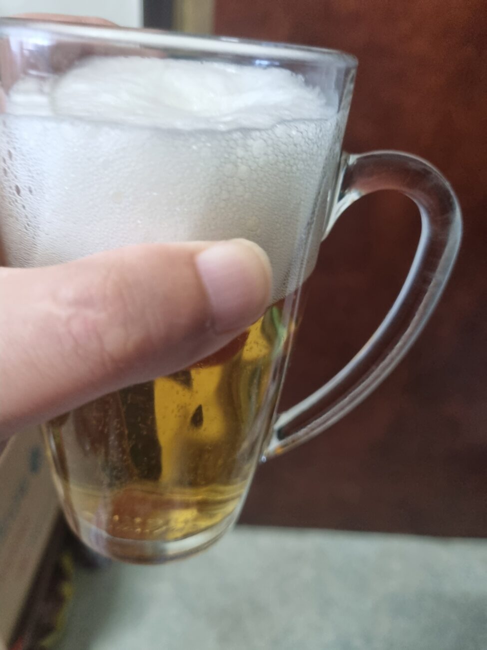 Suntory Nama beer poured into a glass with head