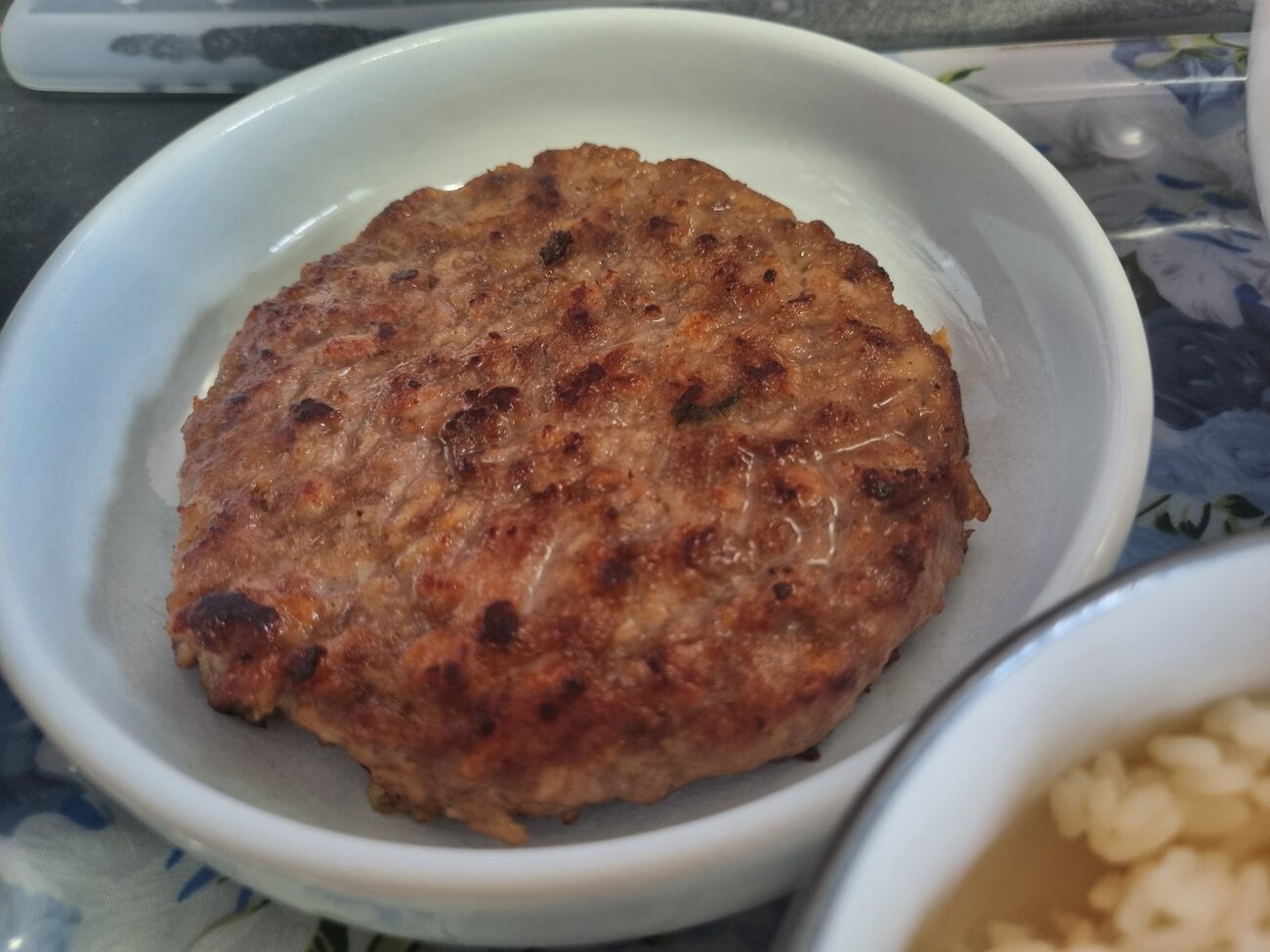 Grilled Korean tteokgalbi patty cut open showing inside