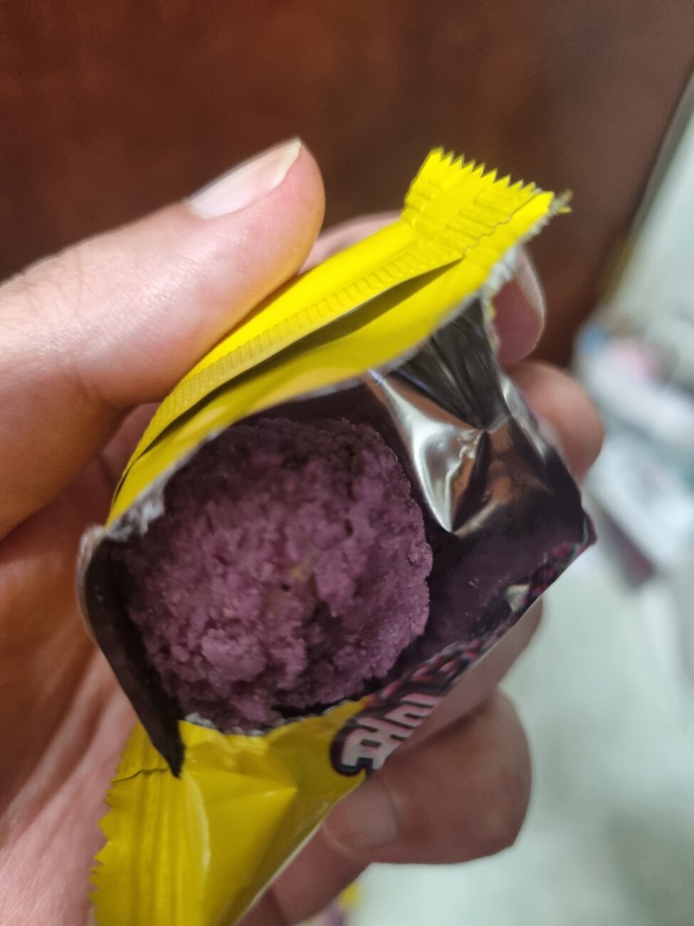 Ube crunch ball cut open showing purple inside