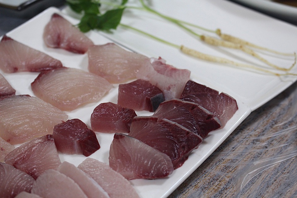 Thick blocky cuts of fatty yellowtail showing pale marbling