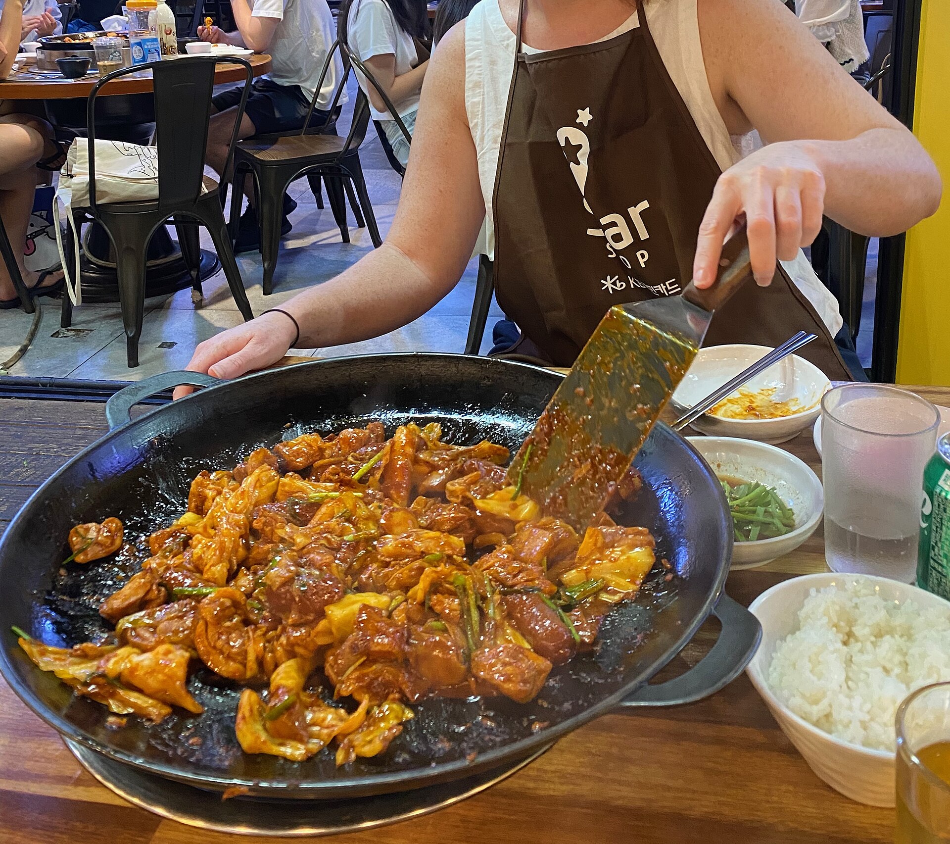 Dakgalbi cooking on a tabletop griddle