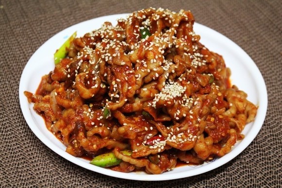 Chicken feet in bright red sauce