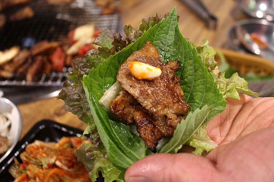 Grilled pork rib meat wrapped in a lettuce leaf