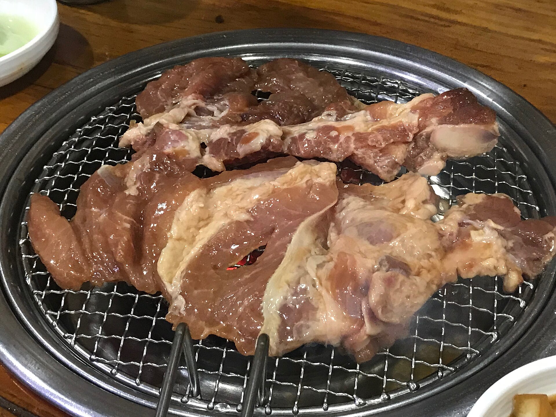 Marinated pork ribs cooking on a grill