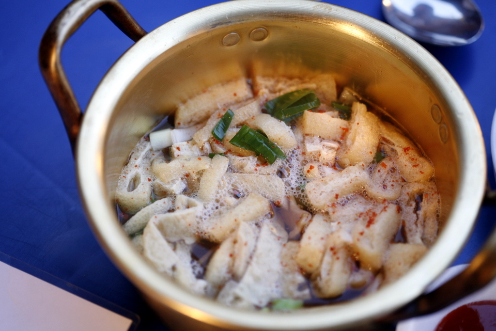 Fish cake on skewers in broth at a street stall