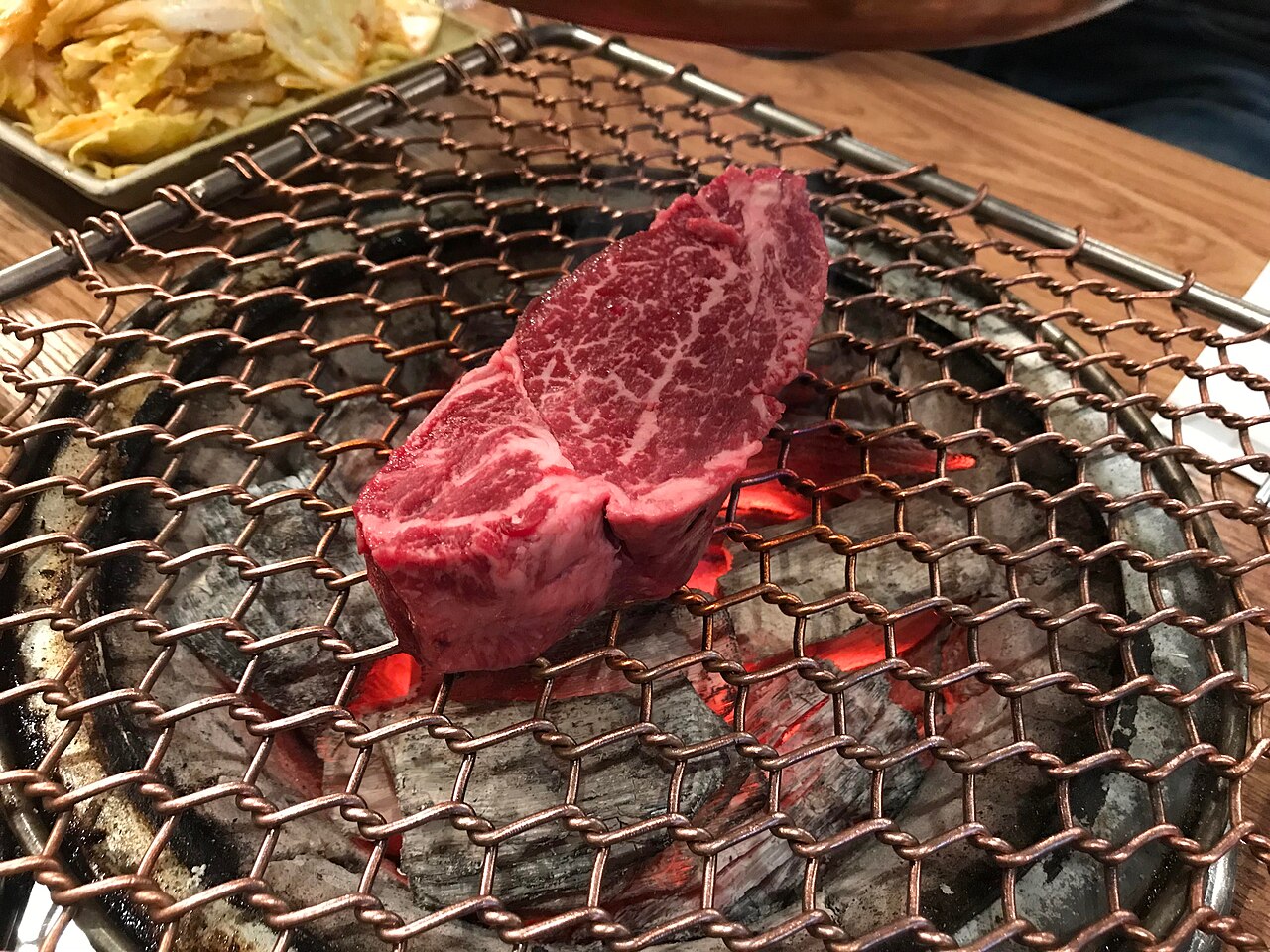 Korean beef grilling over charcoal