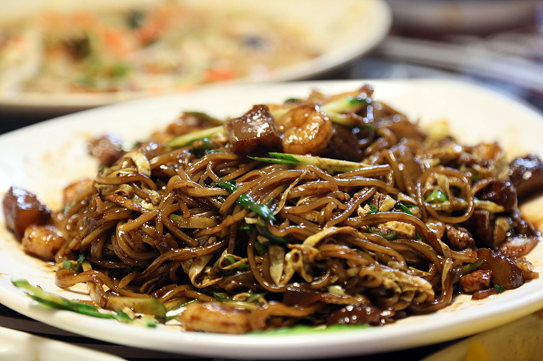 A wide platter of black bean noodles for sharing