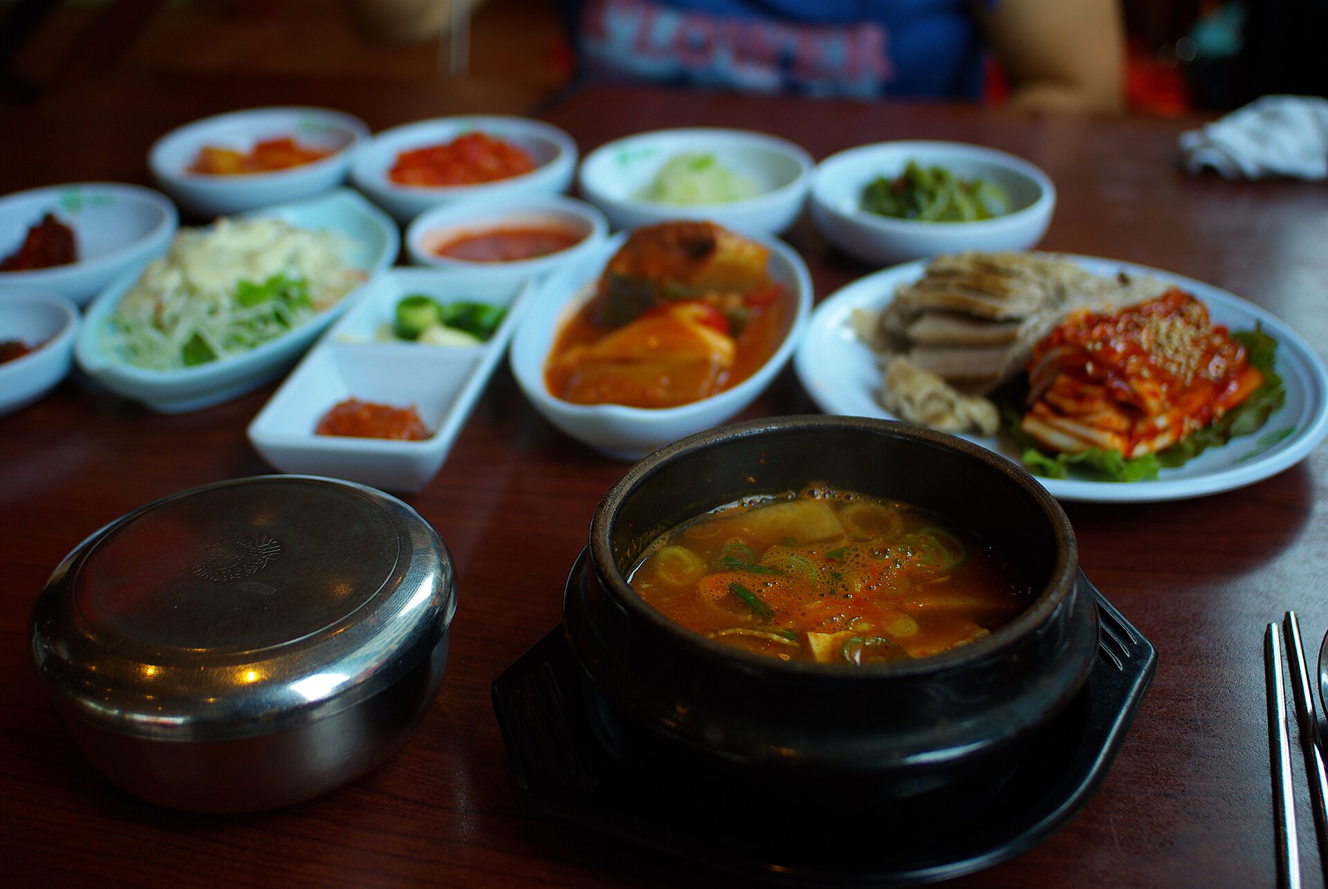 A pot of soybean paste stew with rice and side dishes