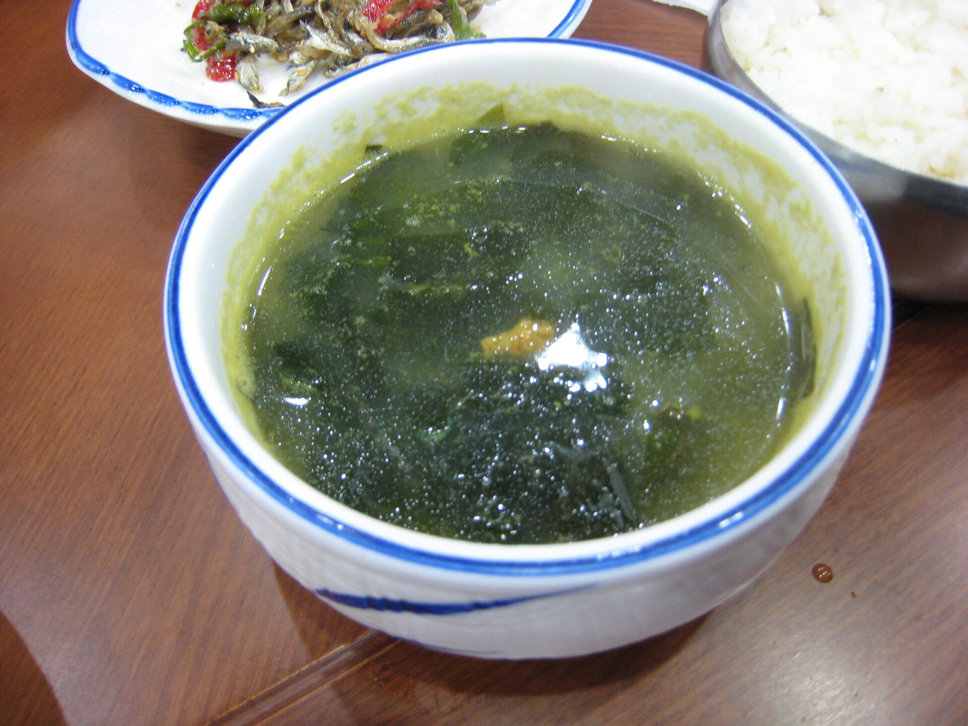 A bowl of dark green seaweed soup