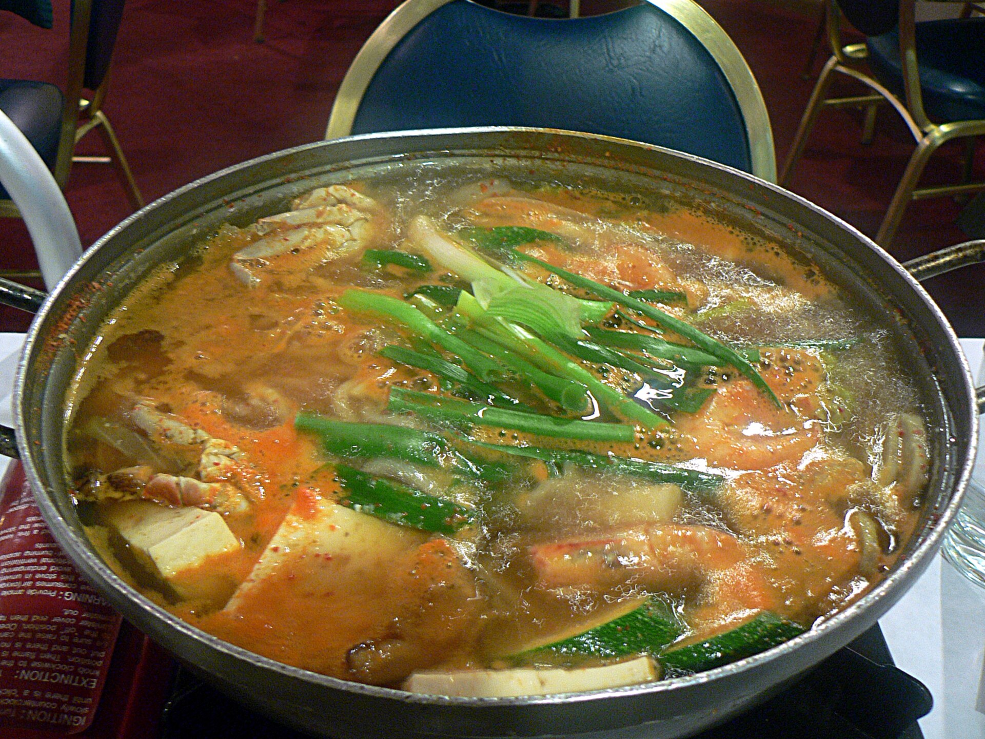 A large bubbling pot of spicy seafood stew