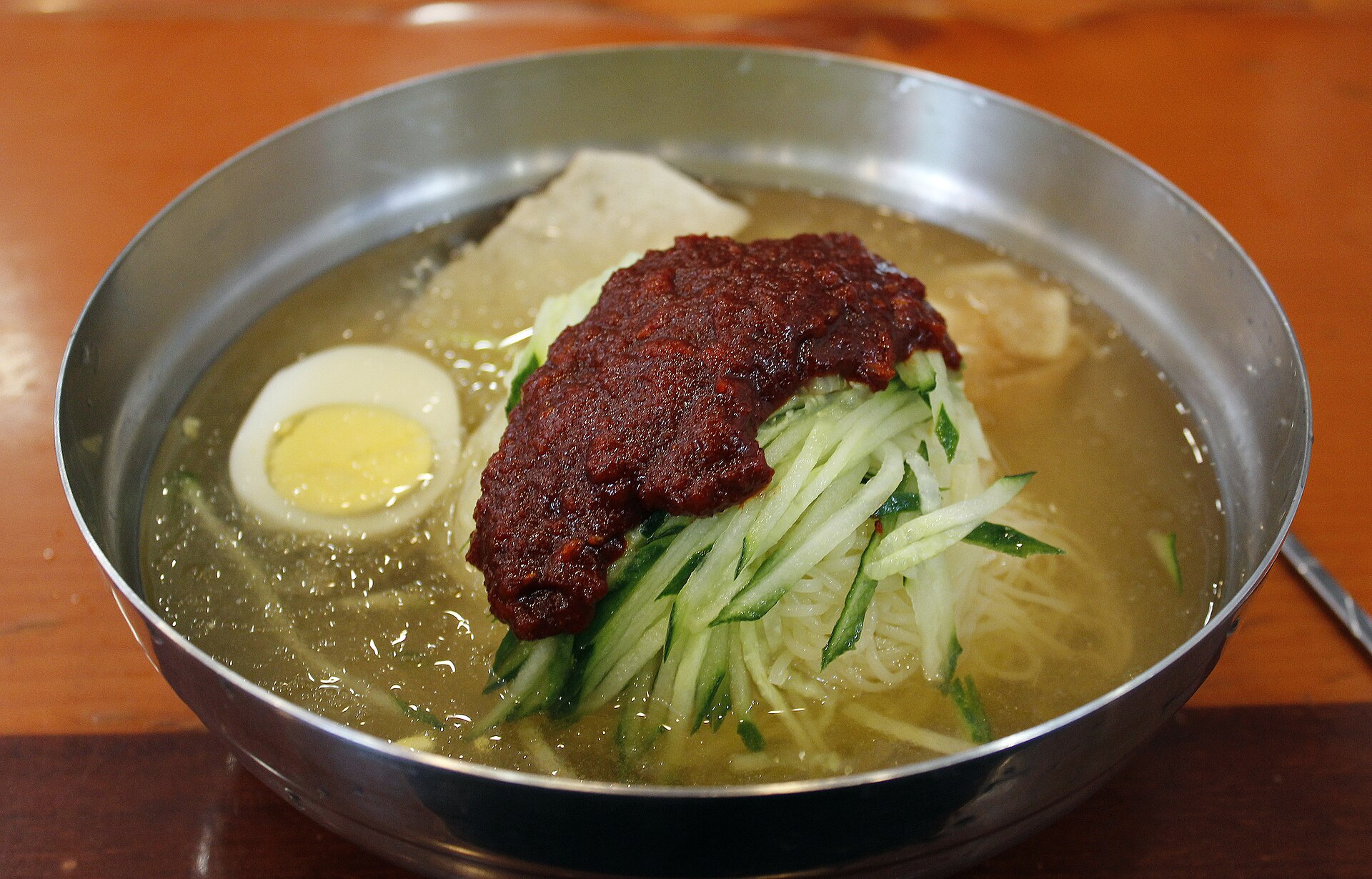 A bowl of Busan cold wheat noodles in chilled broth
